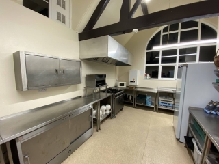 The commercial-style kitchen at Horton Village Hall is fitted with a range of appliances. Pictured is the gas cooker/stove along with the warming cupboard, water boiler, microwave and extractor fan.