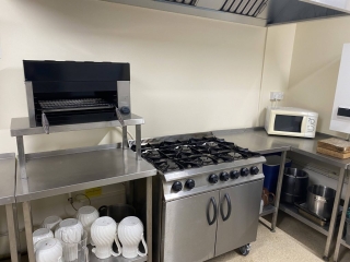 The commercial-style kitchen at Horton Village Hall is fitted with a range of appliances. Pictured is the gas cooker/stove along with the kettle and microwave.